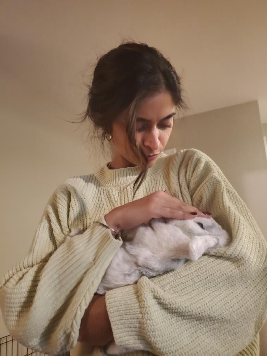 Preet smiling while holding a bunny