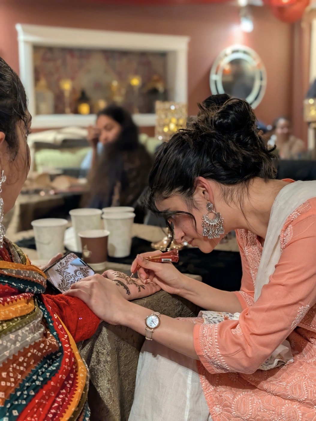 Preet applying henna at an event
